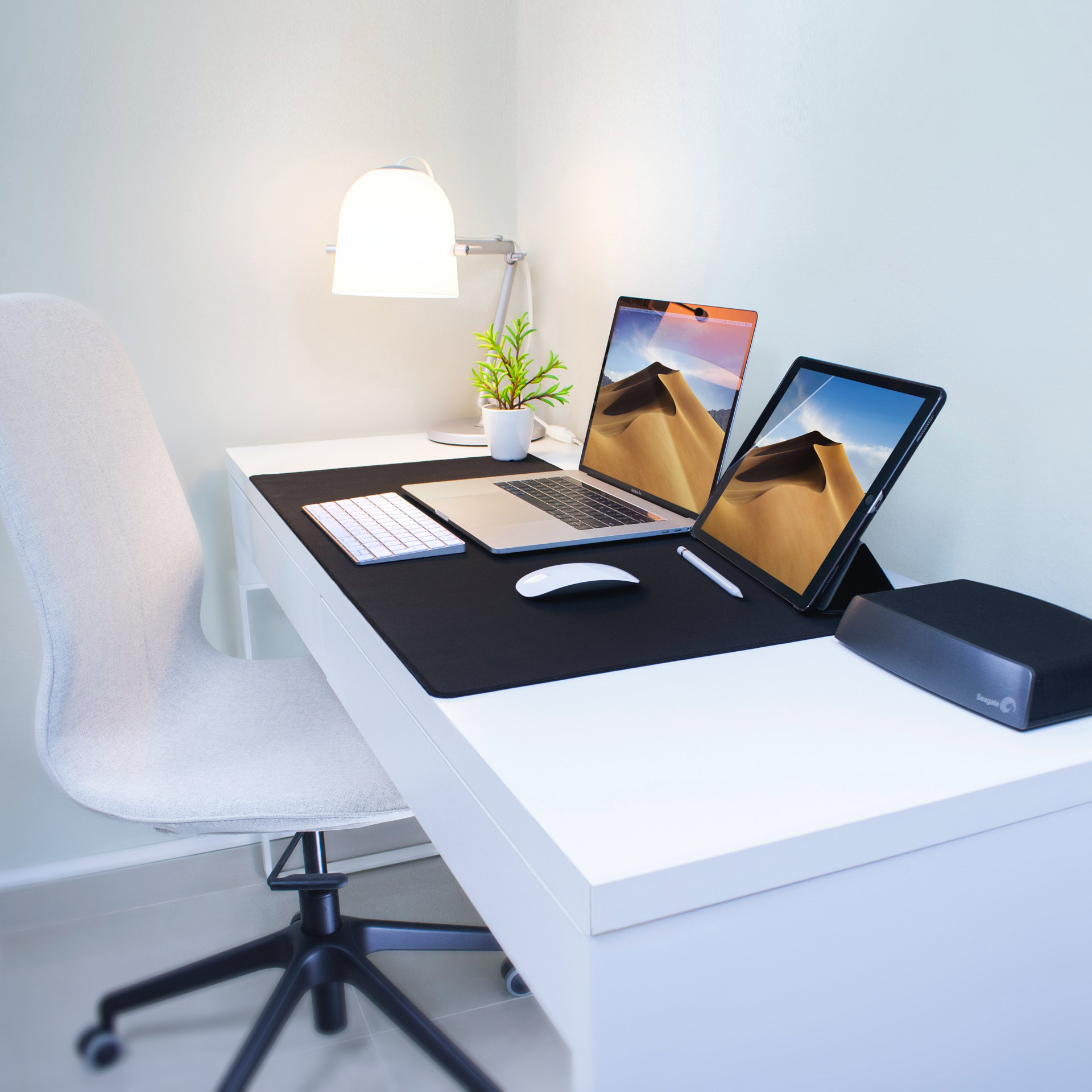 white office with a surface laptop and surface tablet and a wireless keyboard and wireless mouse