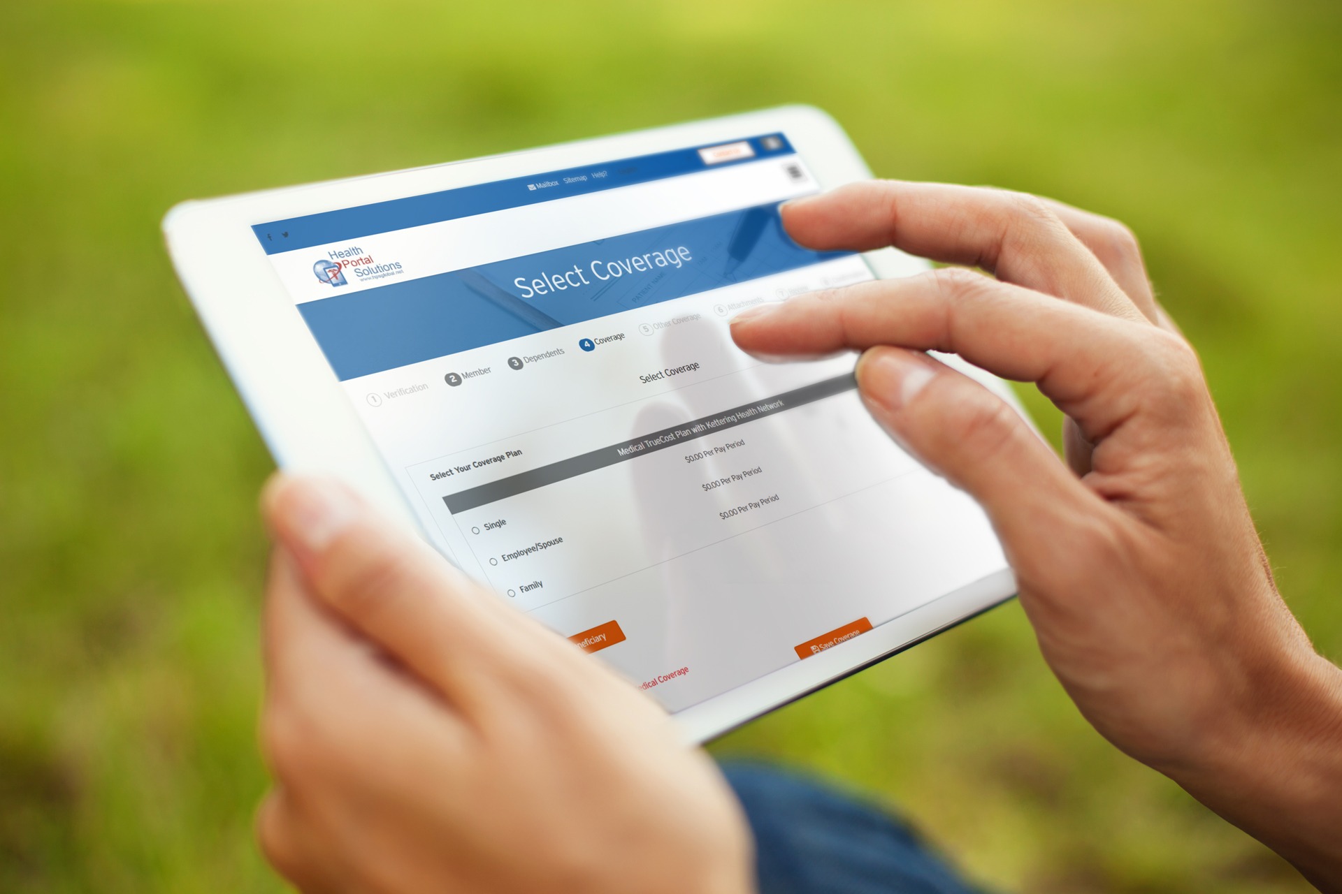 close up of hands touching ipad to select coverage while person is standing on the grass