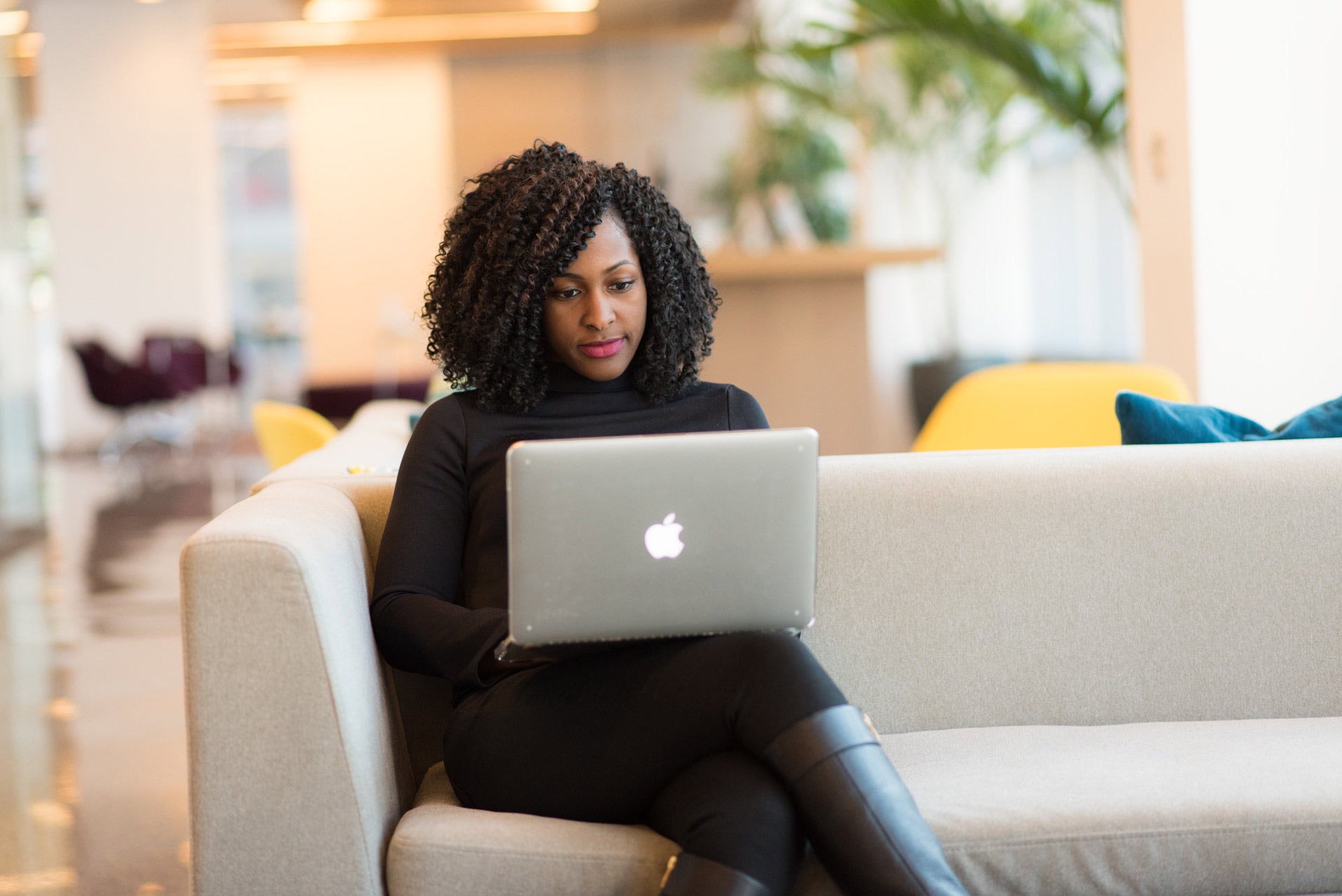 woman sitting on a sofa with a laptop