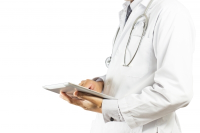 torso of a doctor with an ipad in hand