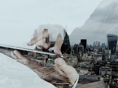 Double-Exposure Businessman with Tablet and the city in the background