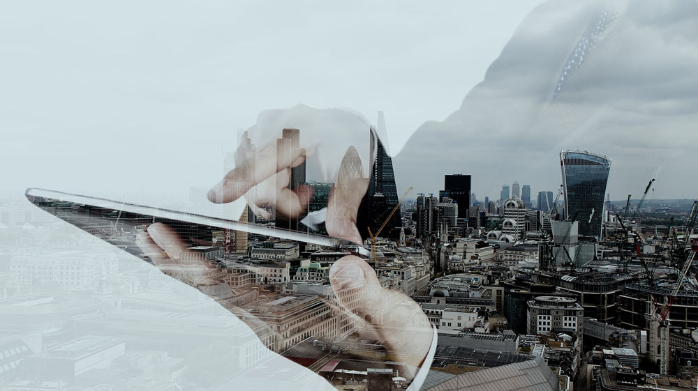 Double-Exposure Businessman with Tablet and the city in the background