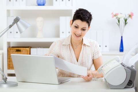 woman looking at a faxed document