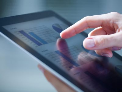 hand pointing to ipad with chart graphics