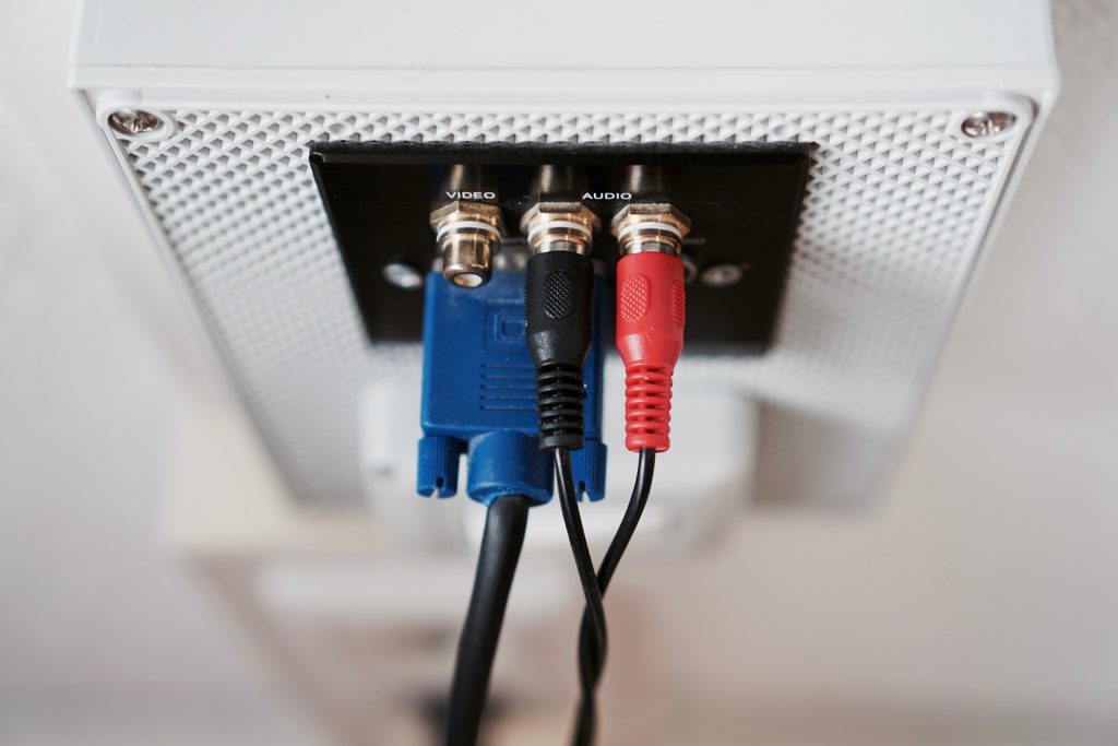 cords inserted to the back of a desktop