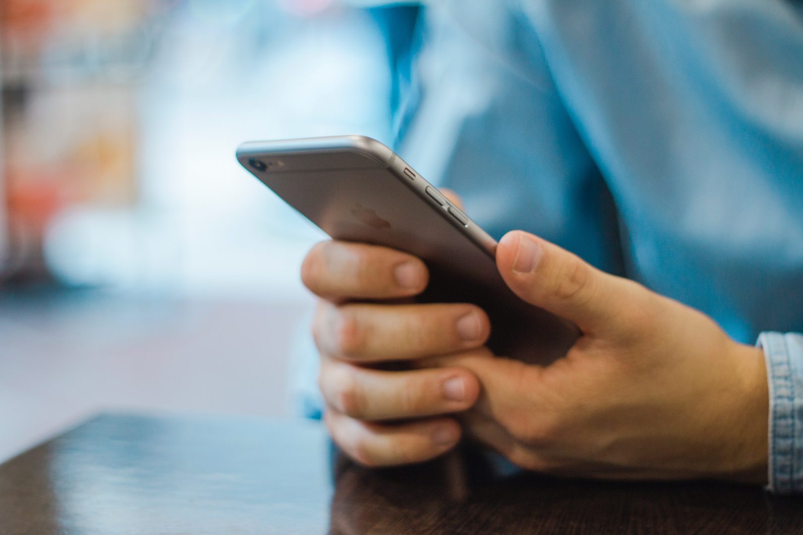 close up of hands grasping an iphone