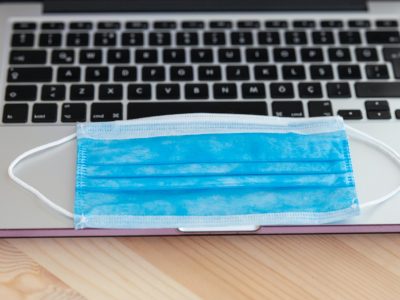 paper face mask on laptop