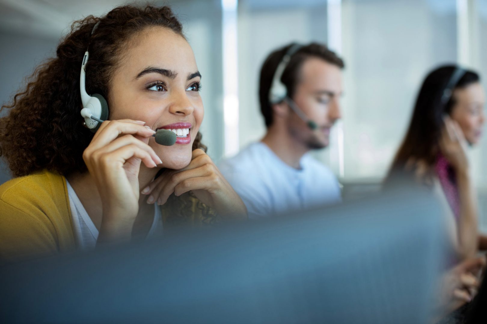 woman with a phone headset one sitting on a call center