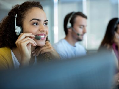 woman with a phone headset one sitting on a call center