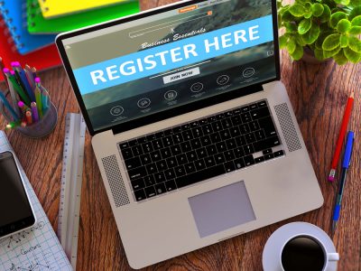 laptop with -register here- text on the screen