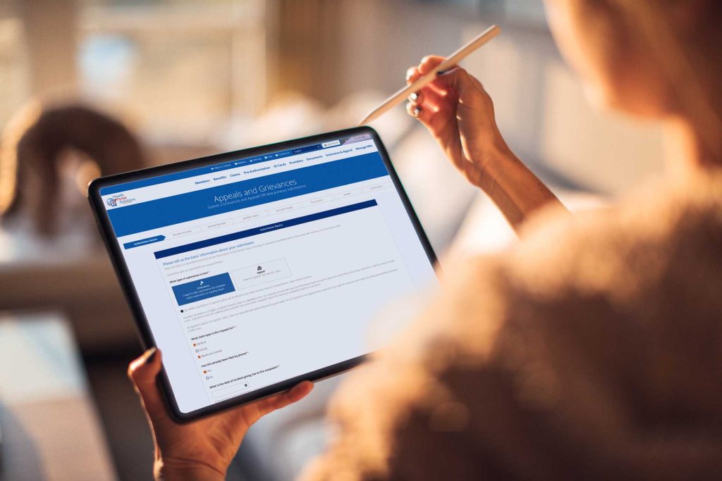 woman on Appeals and Grievance form on iPad