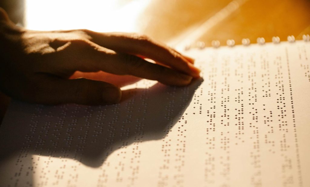 person reading braile text