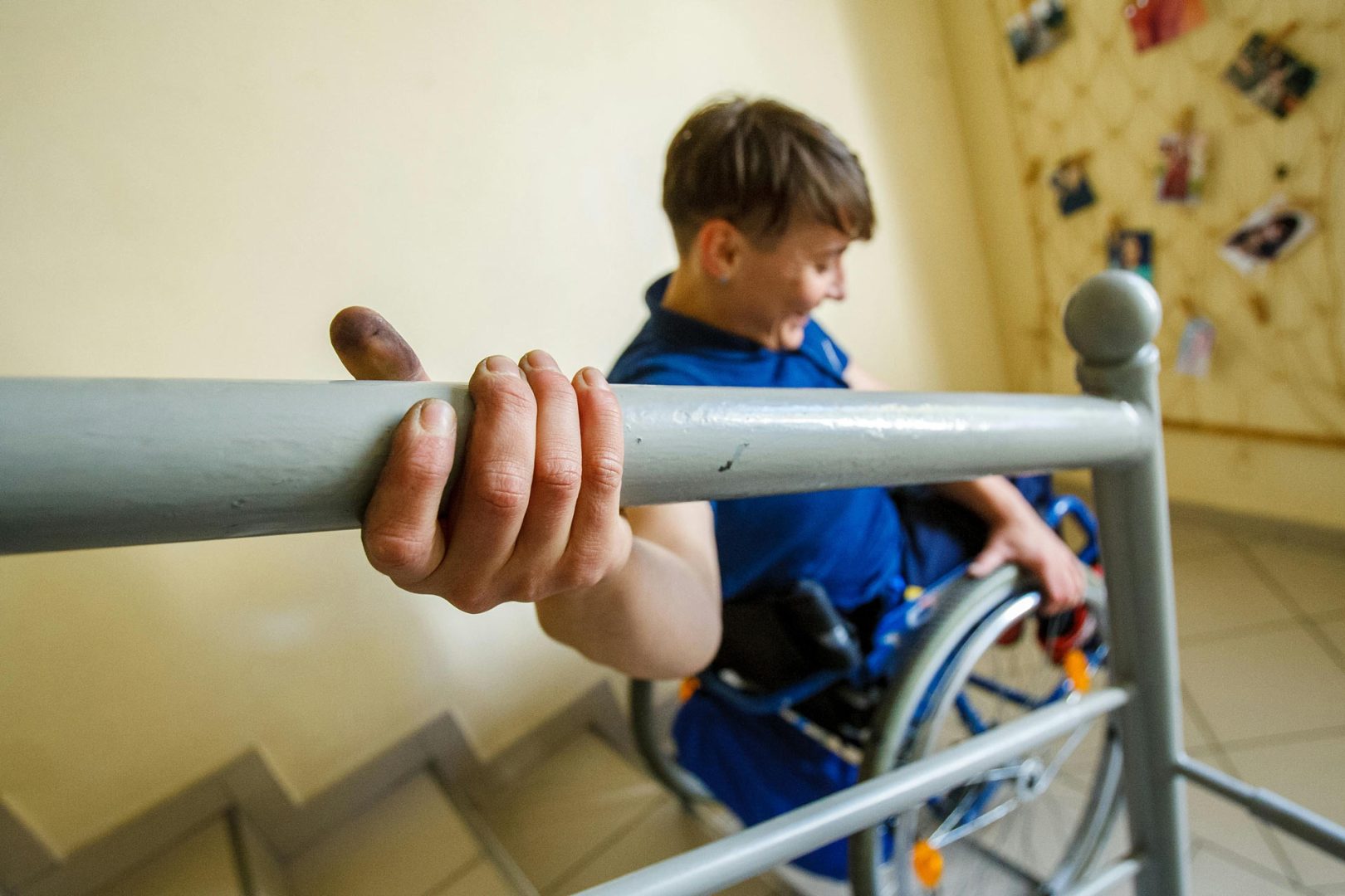person struggles to descend stairs while in a wheelchair